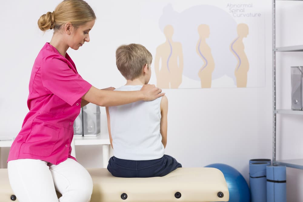 therapist-correcting-childs-posture